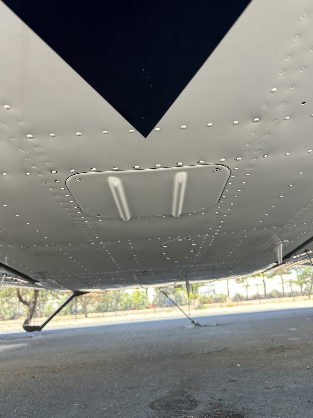 Aircraft belly and underside after degreasing, bare aluminum cleaned back to a reflective finish