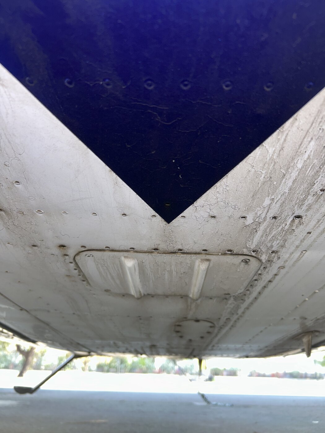Aircraft belly and underside before detailing, streaked with exhaust residue and grime
