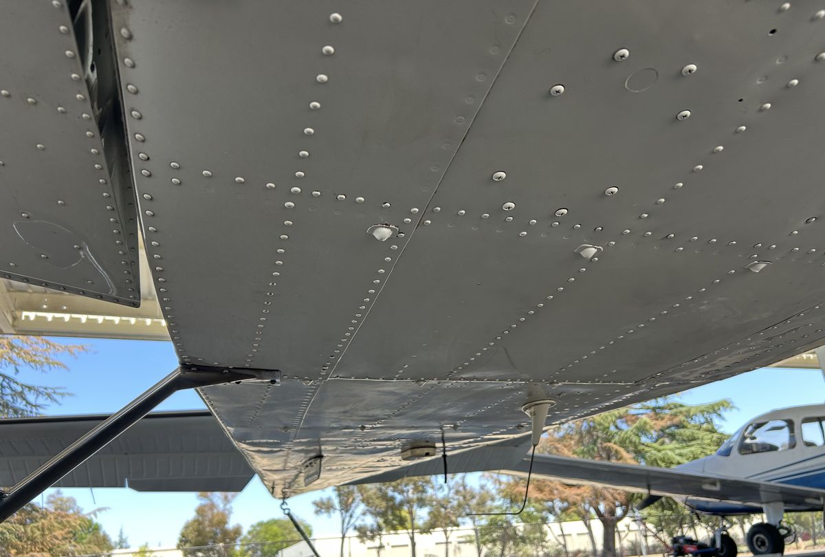 Aircraft belly and underside after degreasing, bare aluminum cleaned back to a reflective finish