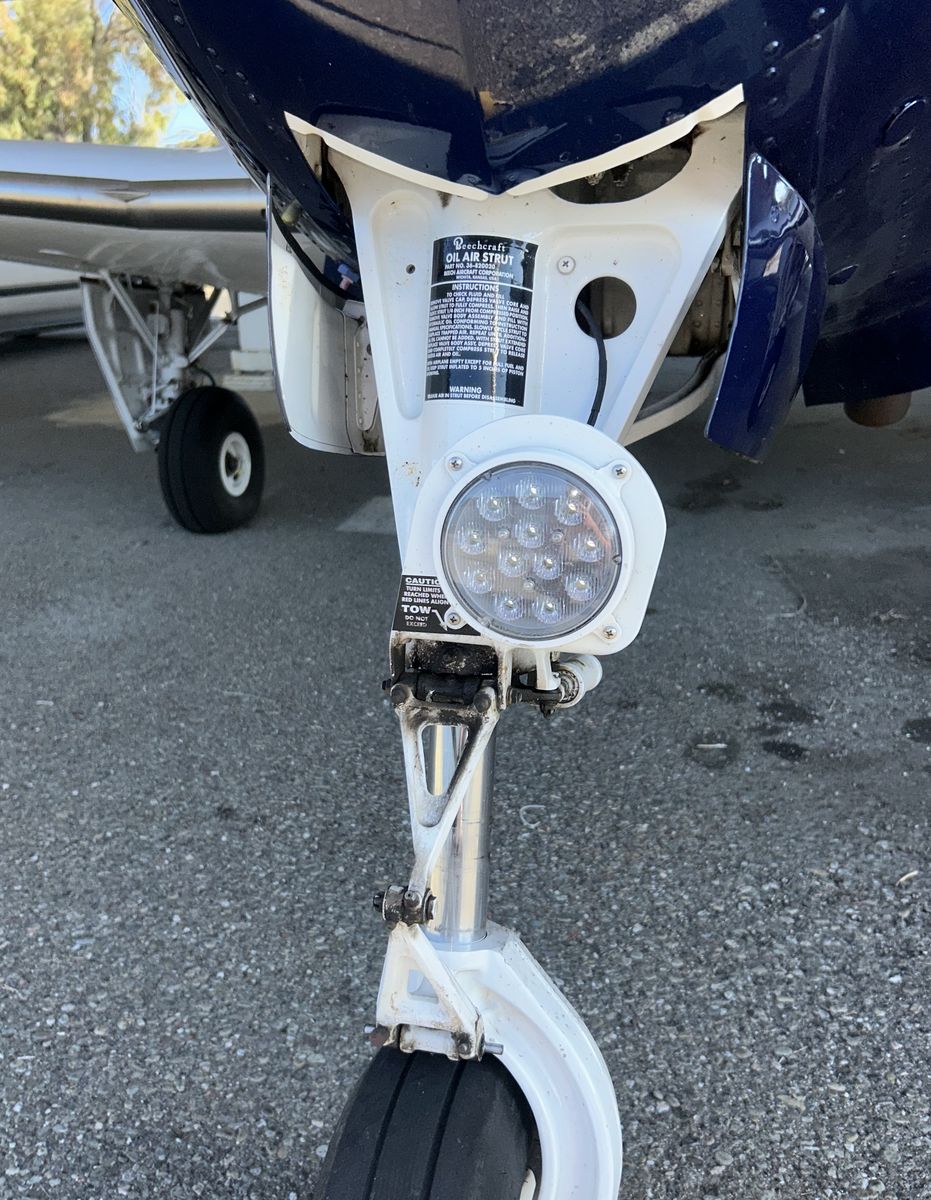Beechcraft nose gear strut, landing light and wheel after a full degrease and detail